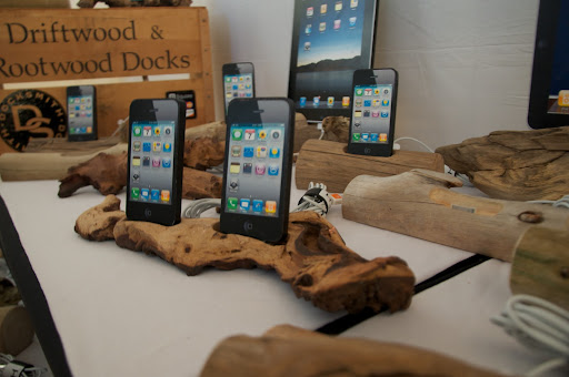 This booth is Docksmith. Lee Goodwin fashions these fantastic electronic docks out of Maine driftwood. http://www.etsy.com/shop/DOCKSMITH