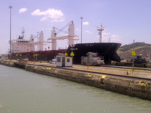 The average toll through the Panama Canal is around US$54,000. A Panama Canal Pilot is required to be on board all ships in the canal. Large vessels are pulled through the locks by locomotives. The locomotives work together to maintain ship position within the width of the locks, as there are sometimes only inches to spare on each side.