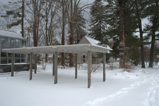 Behind the greenhouse is a shade pergola for tropical plants in the summer.
