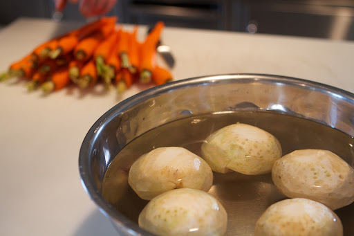 The celeriac was neatly trimmed and placed in a bowl of cold water to prevent browning before cooking.