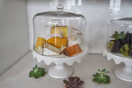 Summer Entertaining: Chocolate mice favors (Burdick Chocolate) and cheeses in a scalloped cake stand and dome (Martha Stewart Collection at Macy's)