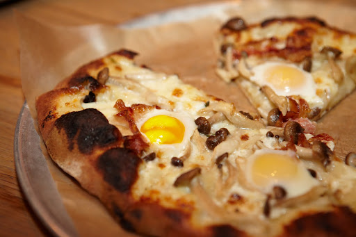 Pizza topped with quail eggs