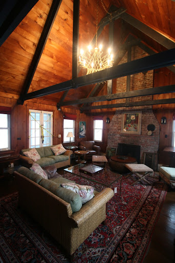 At the other end of the rambling residence was another den with a vaulted ceiling filled with wicker and leather furniture.