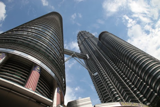 These are Malaysia's famous Petronas Towers, designed by architect César Pelli, who is known for designing some of the world's tallest buildings.