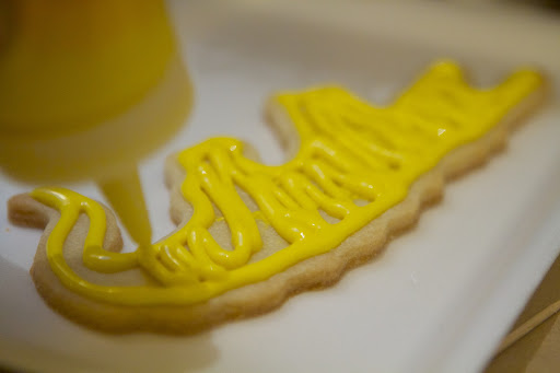 With royal icing, you first outline, to create a border or dam. You then fill or flood the outlined area with more icing.