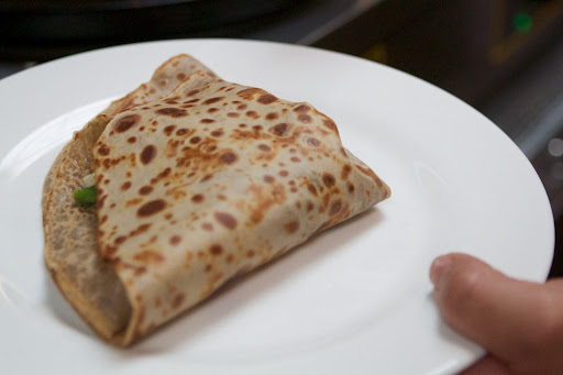 When the fillings are warmed, the crêpes are folded again.