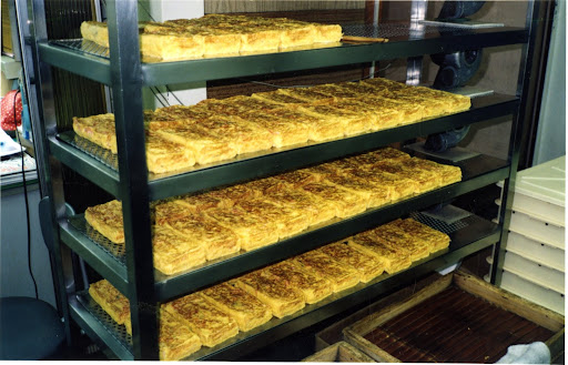 This is tamagoyaki, a type of Japanese omelet, which is made by rolling together several layers of cooked egg. It was fabulous at the market.