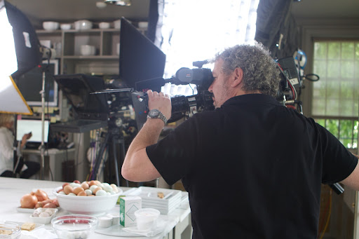 The camera crew calibrated their equipment to work well with the lighting in my kitchen. You can see me in the background checking email as I waited for them to finish.