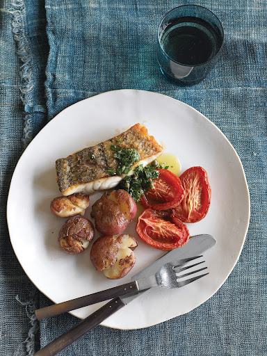 Seared fish with Roasted Potatoes and Tomatoes - In this recipe, flavorful sides complement simply prepared fish without introducing too many extra calories to the meal.