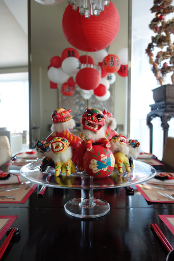 I needed to leave space for platters of food on the table, so I used a glass cake stand to hold a collection of clay bobble-head Foo dogs that I bought in Beijing years ago with Martha.