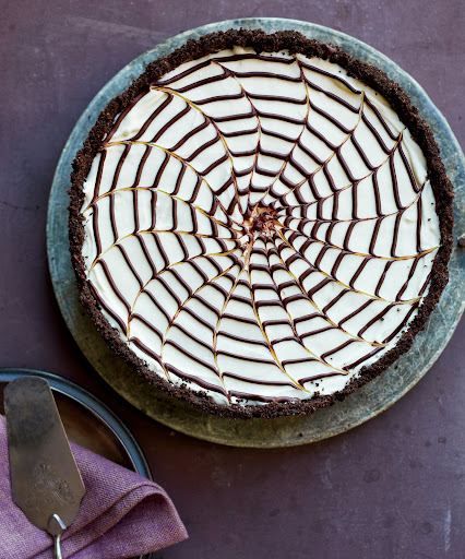 No-Bake Spiderweb Cheesecake - This Halloweeen-worthy dessert is really just a supereasy cheesecake with a deep, dark cookie crust. Serve it at any time of the year without the spiderweb design.