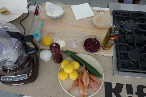 These are the ingredients for the Fatoush with Crumbled Feta, a popular Middle Eastern salad that combines whole-grain pita, kidney beans, and cucumber. In this version, feta is sprinkled over the top.