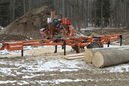 This is Dominic's Wood Mizer sawmill and from all of the new sawdust on the ground, it's obvious he's been cutting lumber.