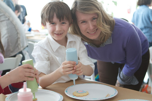 Daniel Ward and his mom, producer Lenore Welby pose for a photo while decorating a cookie together