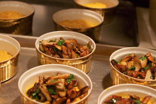 The cooked risotto was spooned into individual serving dishes, topped with the sautéed mushrooms, and garnished with chopped parsley.