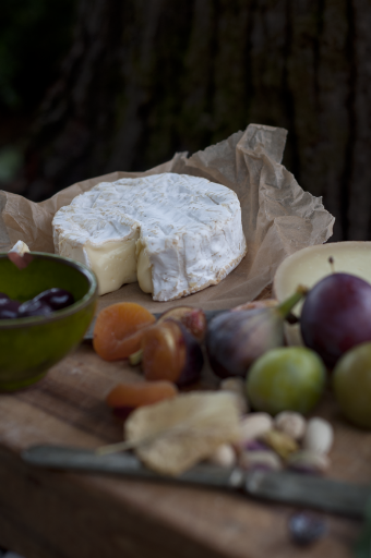 A still life with cheese and fruit