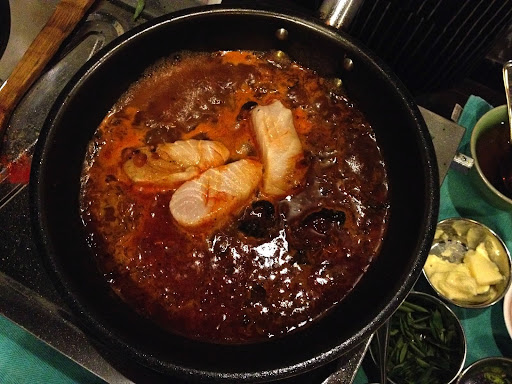 The next dish was the popular Kerala Fish Curry, made from King fish. Fish Masala, a pre-made spice mix of garlic, chili, fengreek, and turmeric, is commonly used to flavor. The black fruit is tamarind, which is dried and then re-hydrated in water. It simmers with the sauce and is removed before serving. It tastes very sour when eaten on its own, but imparts great flavor.