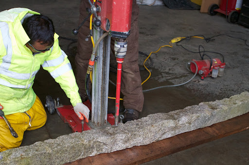 The posts were taken to the equipment barn where holes for the wire to pass through were drilled using a core drill.
