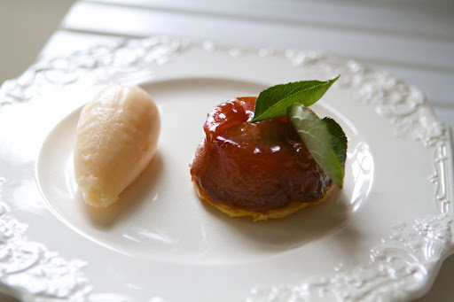 The apple tart tatin with quince sorbet garnished with apple leaves - Perfectly refreshing!