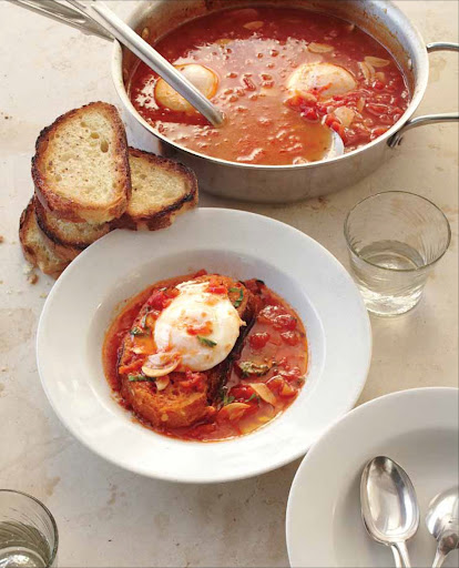 Tomato Soup with Poached Eggs - Poached eggs, with their rich, runny yolks and high protein content, have a way of elevating practically any meatless dish–even an easy tomato soup–into a main course. In this one-pot recipe, the eggs are cooked right in the soup; then eggs and soup are spooned into serving bowls over garlic-rubbed toast.
