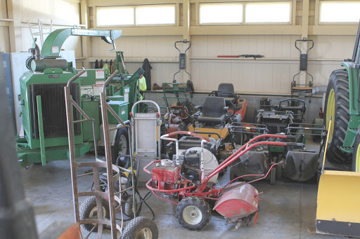 This area houses more mowers, blowers, tillers, and hand trucks. The wood chipper is also parked here.