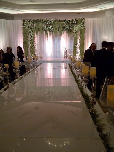 The Chupa, wedding canopy, made of green roses and amaranthus. Men sat on the right and women sat on the left.
