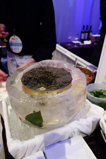 A large tin of caviar staying cold in an ice bowl