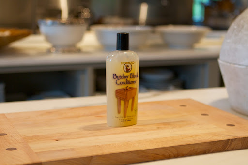 For wooden cutting boards, we use Howard Butcher Block Conditioner, which can also be used on wooden bowls and utensils. The penetrating quality of food-grade mineral oil along with the water-resistant traits of beeswax and carnauba wax rejuvenates the wood and prevents drying and cracking. www.howardproducts.com