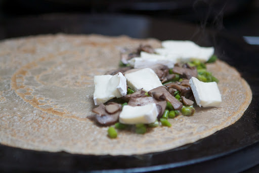This crêpe has a filling of crimini mushrooms, leeks, and brie.