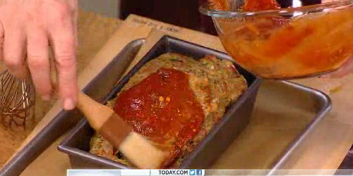 The glaze is brushed over the top of the meatloaf. This is the gilding of the lily, giving a really great crust and a delicious flavor.