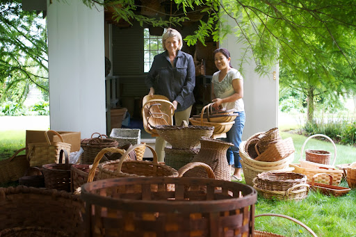 Here we are holding traditional English garden baskets called trugs. They were handmade using bent wood and fastened with copper tacks. They are sturdy, functional, and beautiful.