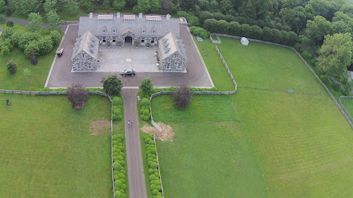 It is my horse stable. My Chow Chow, Ghenghis Khan, loves to play in the small paddock on the upper right, which is sectioned off from the large horse paddock by an electric fence. If you look closely, you can see Dominic near the gate in the boxwood allee.