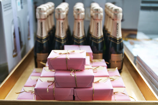 Favors: handcrafted boxes filled with chocolate balls, mini Champagne bottles (Chandon Brut Classic, $7)