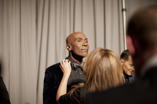 Fashion designer Reem Acra did last minute adjustments to Preston's tie. She designed his custom tuxedo. Photo credit: Mel Barlow