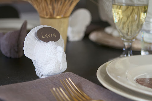 Small turkey candle molds make perfectly sized place-card holders. A miniature serrated hobby saw was used to make small slits along the turkeys' backs to hold the name cards.