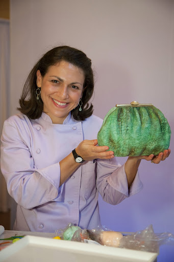 This clutch is actually a cake by Elisa Strauss. It has an incredibly detailed faux texture. http://www.confetticakes.com/designer.html