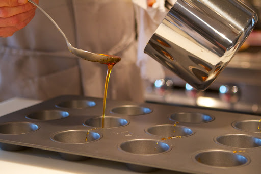 A bit of that caramel was spooned into the bottoms of a muffin tin.
