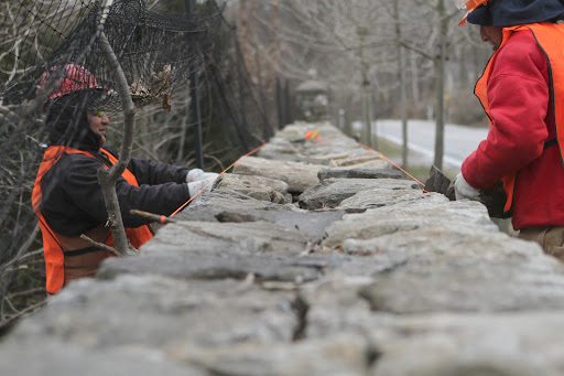 Like the stones for the upright rows, the capstones are carefully chosen by these expert wall builders to interlock and hold the two walls together.