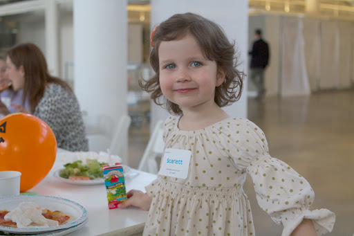 As soon as Scarlett finished her lunch, she was ready to head to the reception stairwell to take a group photo with all the kids