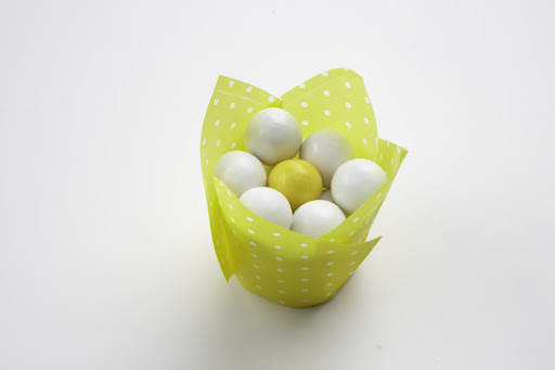 Darcy always finds alternate uses for everyday items. Here, she uses a paper cupcake wrapper as a dish for colorful gum balls.