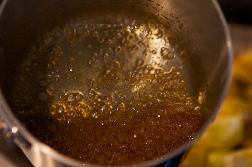 Meanwhile, Pierre caramelize sugar in a saucepan.