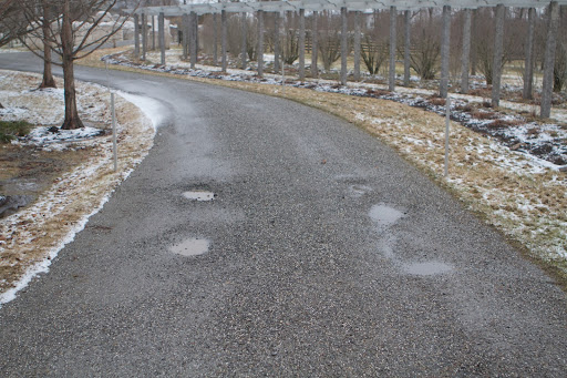 For much of the winter, the gravel roads at my farm were covered with compacted snow which turned to ice. When all that ice melted, many potholes formed on the road surface.