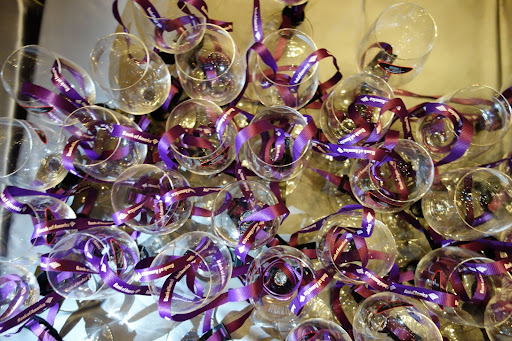 Upon entering the ballroom, guests are each given a wine glass.