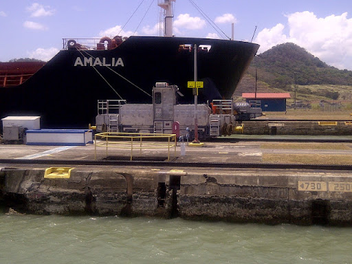 Here's a shot of a locomotive pulling a ship. The Canal measures 48-miles (77.1 kms) long. Completed in 1914, the Panama Canal is one of the largest and most difficult engineering projects ever undertaken.