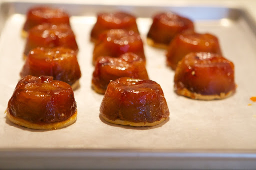 The tarte tatins were removed from the baking tin and inverted on their pastry bases.