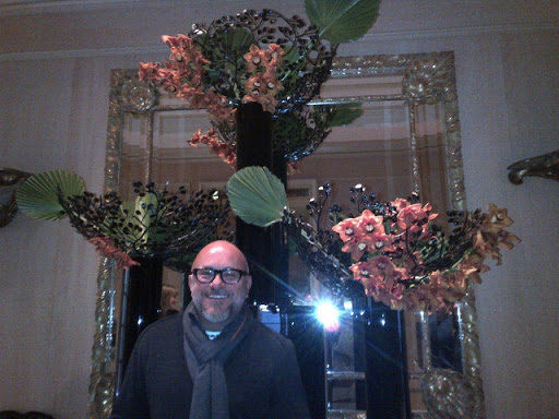 This is famed floral designer, Eric Buterbaugh, who is based in Four Seasons. Here he is in the lobby of the hotel standing before one of his fantastic creations - cymbidiums with wrought iron branches and fan palms.