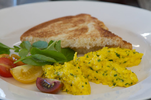 We served our guests a colorful breakfast of vibrant soft scrambled eggs from my own chickens, tomato coulis, and brioche toast with my homemade jam. The eggs were flavored with parsley and chives and formed into quenelle shapes.