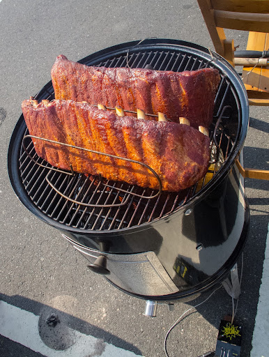 Time to switch the ribs on the top rack with the bottom rack and spritz them with some apple juice. See how the meat is starting to pull back from the bone? That’s a good thing!