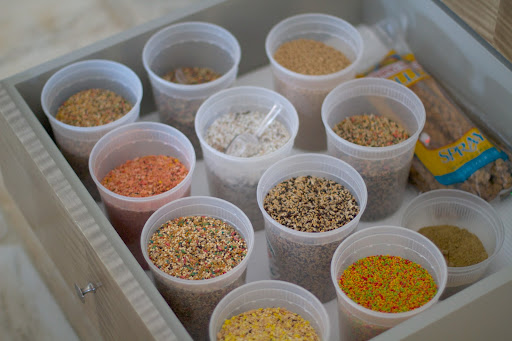 The canary seed mixes are kept in a drawer in covered containers. We feed them a variety of mixes with added vitamins and minerals. We also give them an eggfood, a baked food containing eggs and other ingredients that provide good animal proteins, vitamins, and minerals.