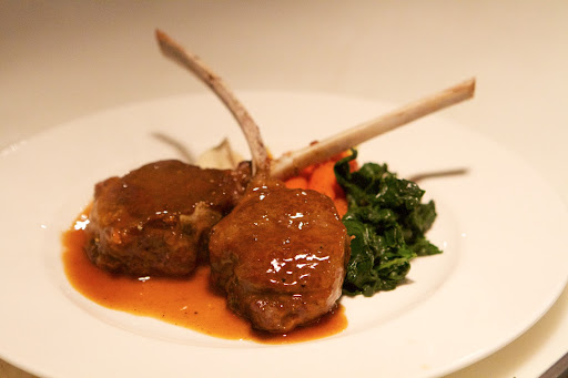The plated lamb chops with the celeric purée, wilted spinach, and baby carrots topped with a rich demi-glace made from the lamb stock - Perfectly delicious!